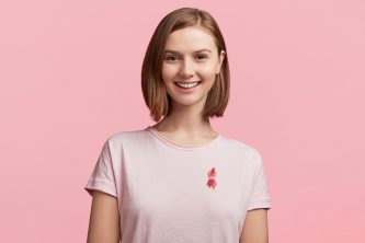 young-woman-wearing-pink-breast-cancer-awareness-ribbon young-woman-wearing-pink-breast-cancer-awareness-ribbon